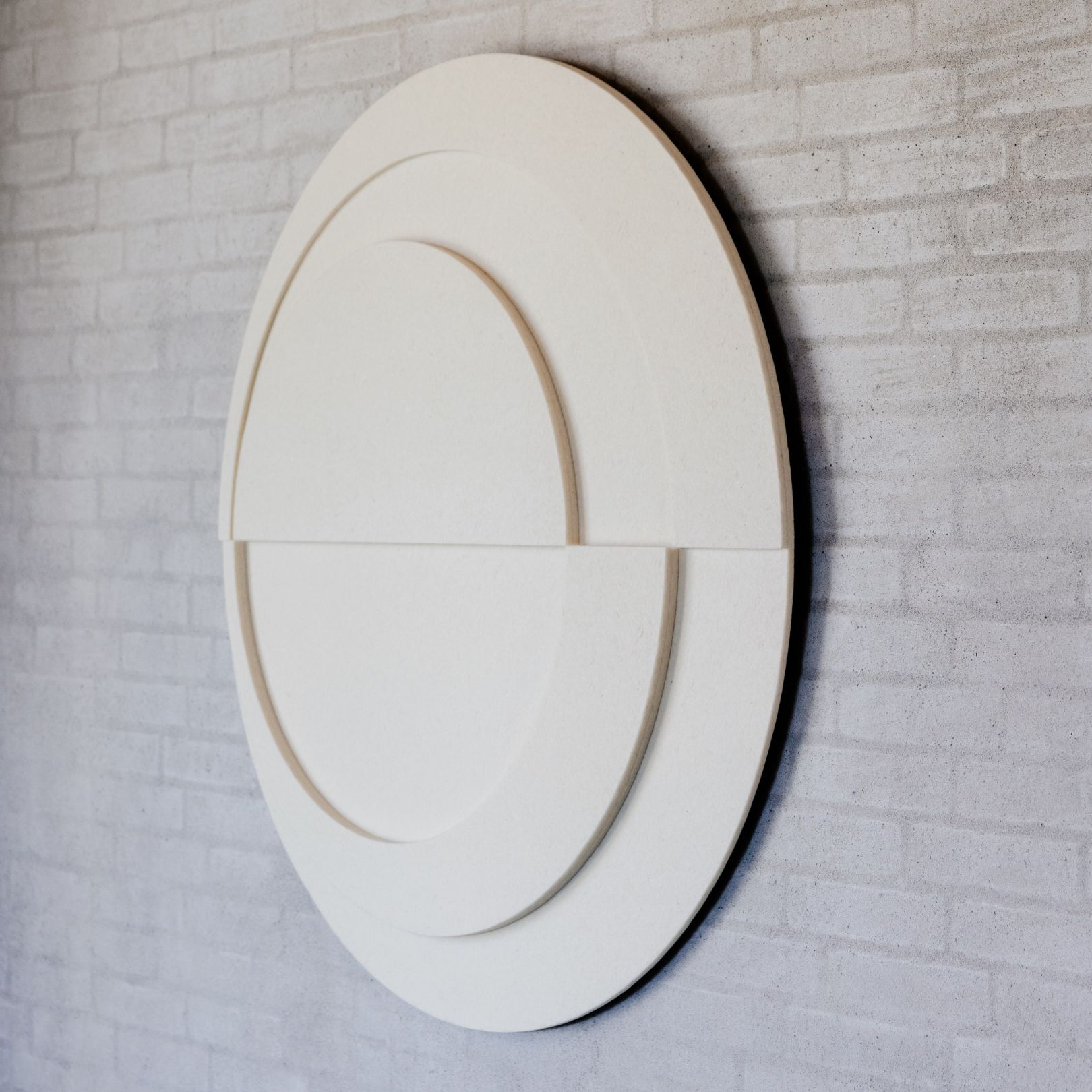 Round acoustic artwork by Arturel x Mandalaki, crafted from recycled textiles for sound absorption and modern aesthetic appeal.