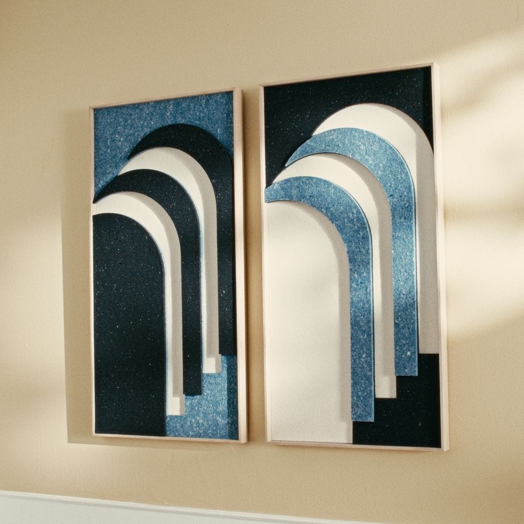 Pair of Danish artwork panels made from upcycled Royal Guard uniforms, featuring layered arches in blue and white.