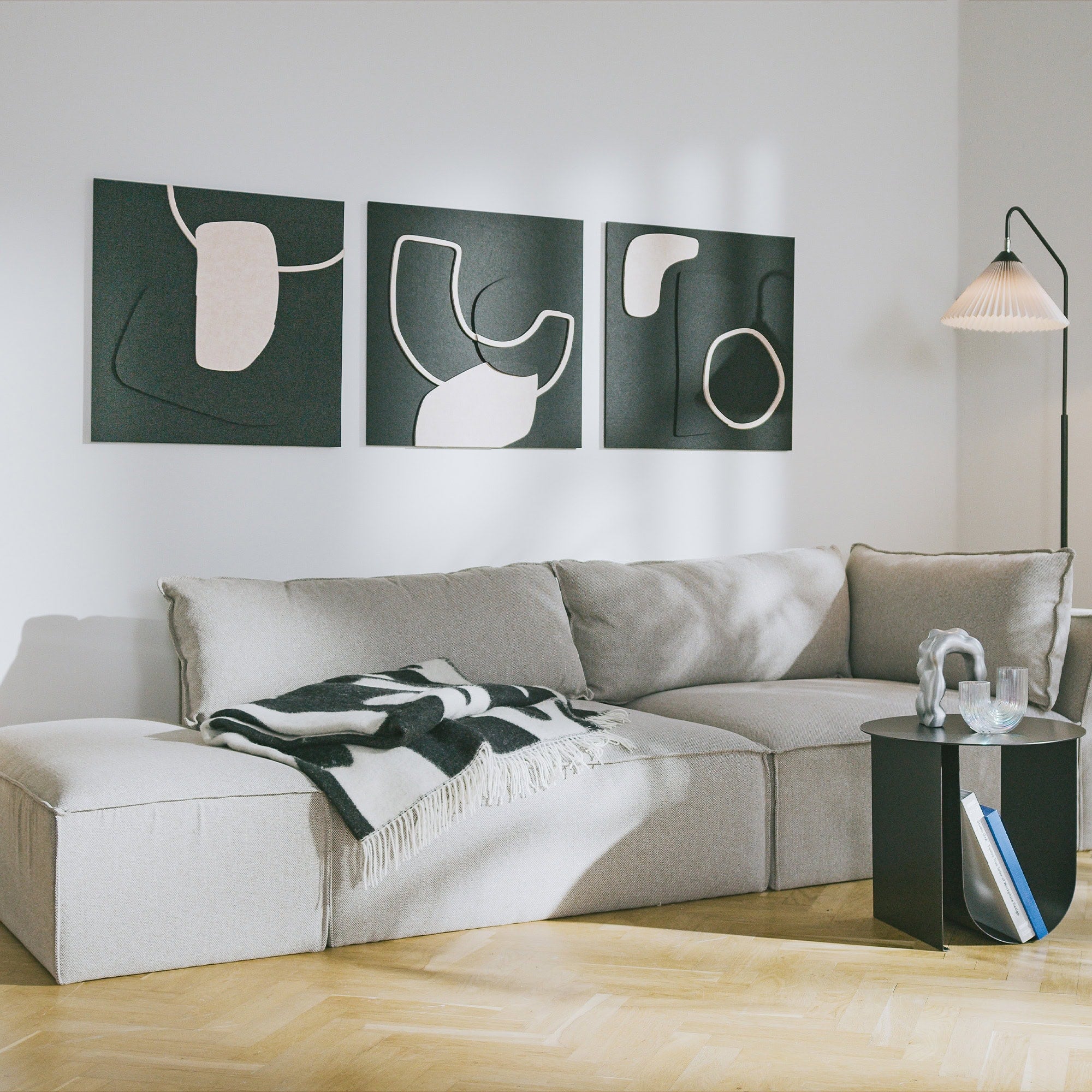 3 acoustic art panels from Arturel's Bauhaus collection hang in a living room and improve the acoustics. Acoustic panel inspiration